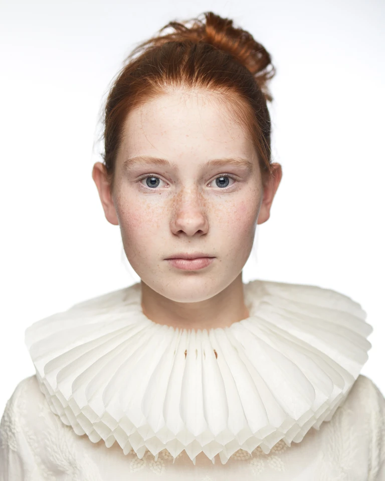 Isabel met rood haar en witte papieren kraag